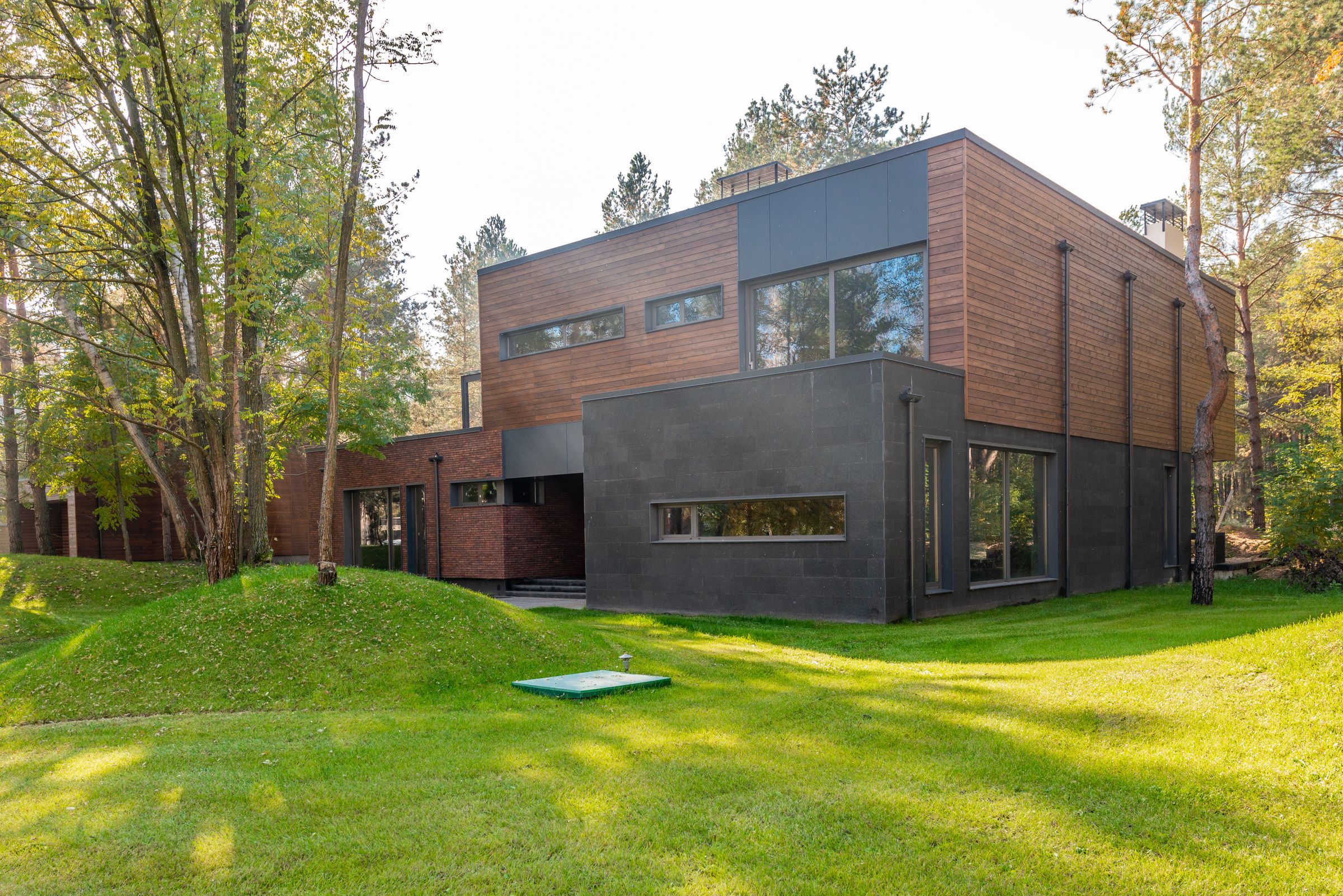 A contemporary custom residence with timber and stone exterior walls
